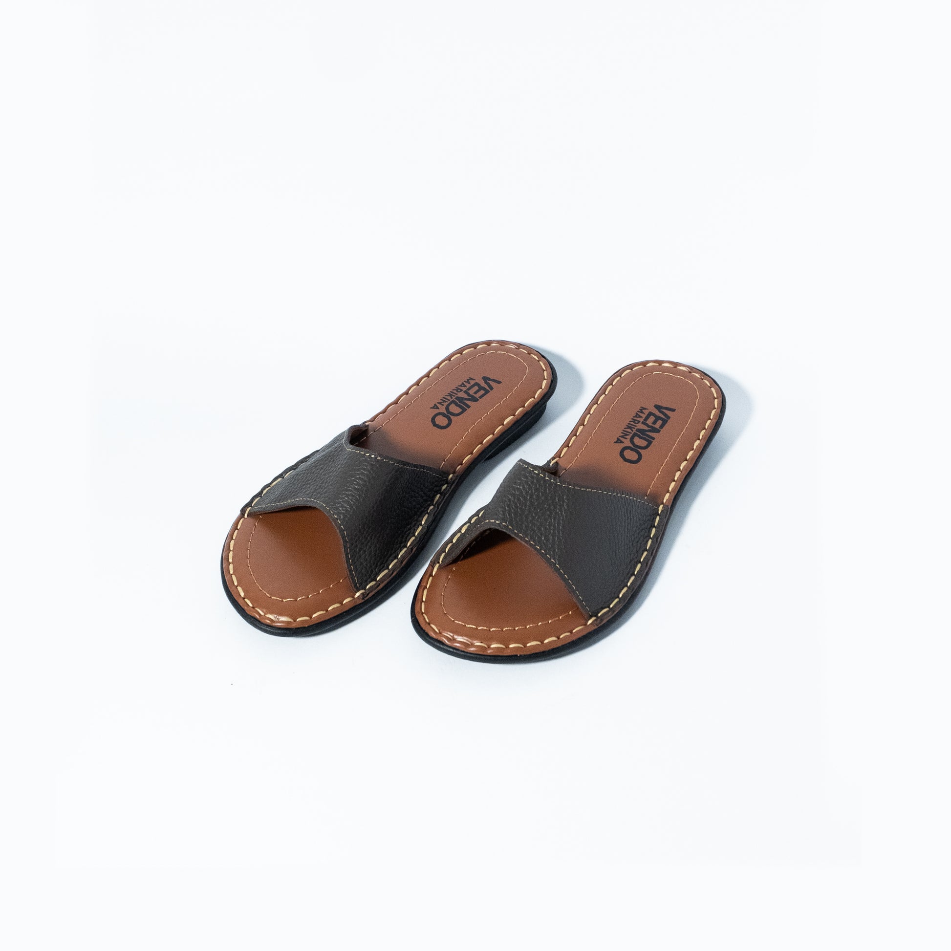 Pair of brown and black sandals on a white background