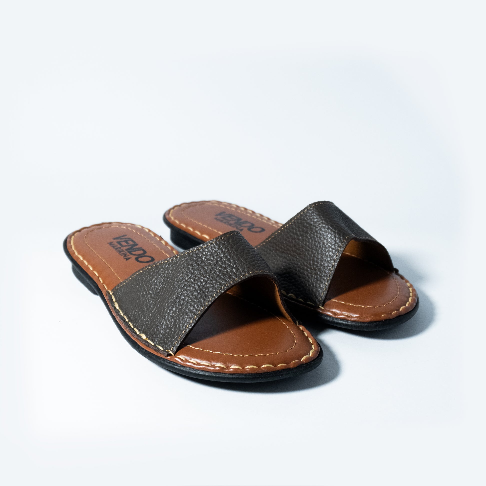 Brown sandals on a light gray background