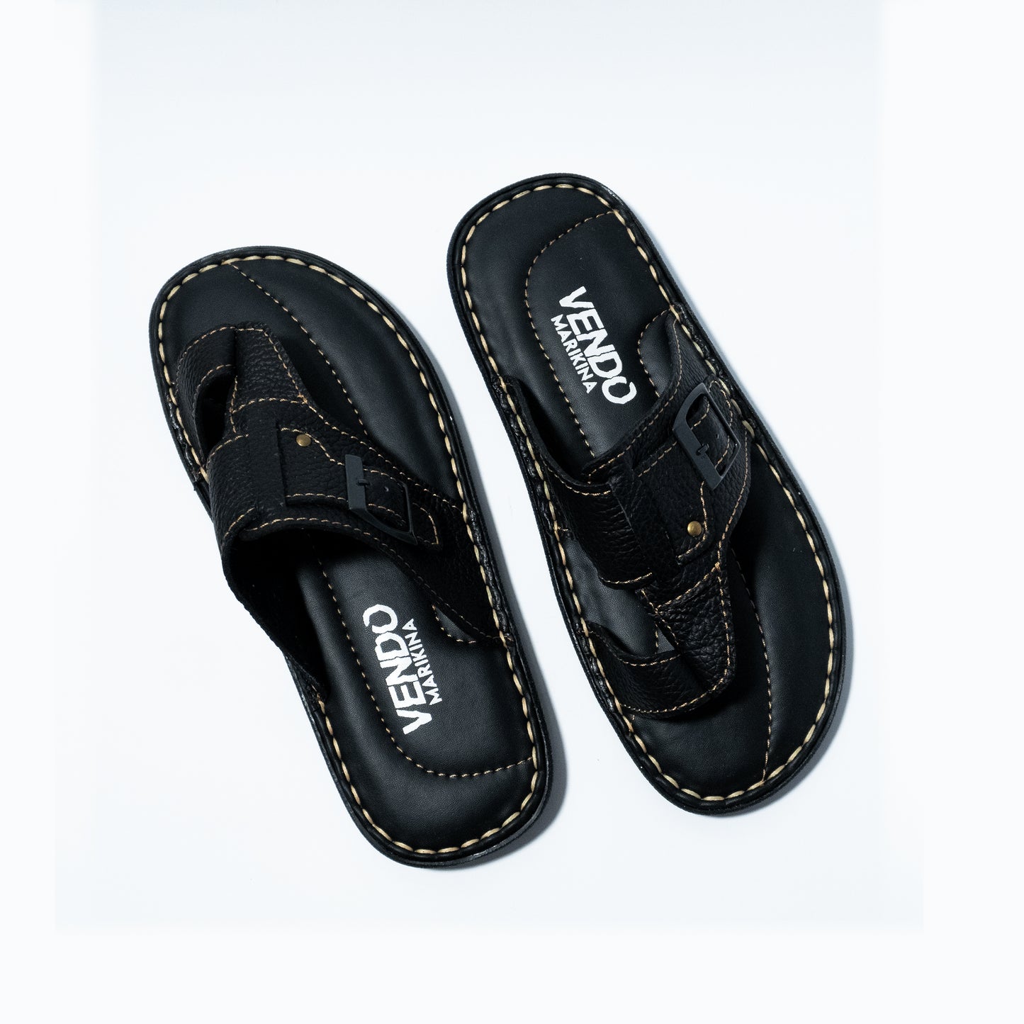 Pair of black sandals with 'VENDO' branding on a white background
