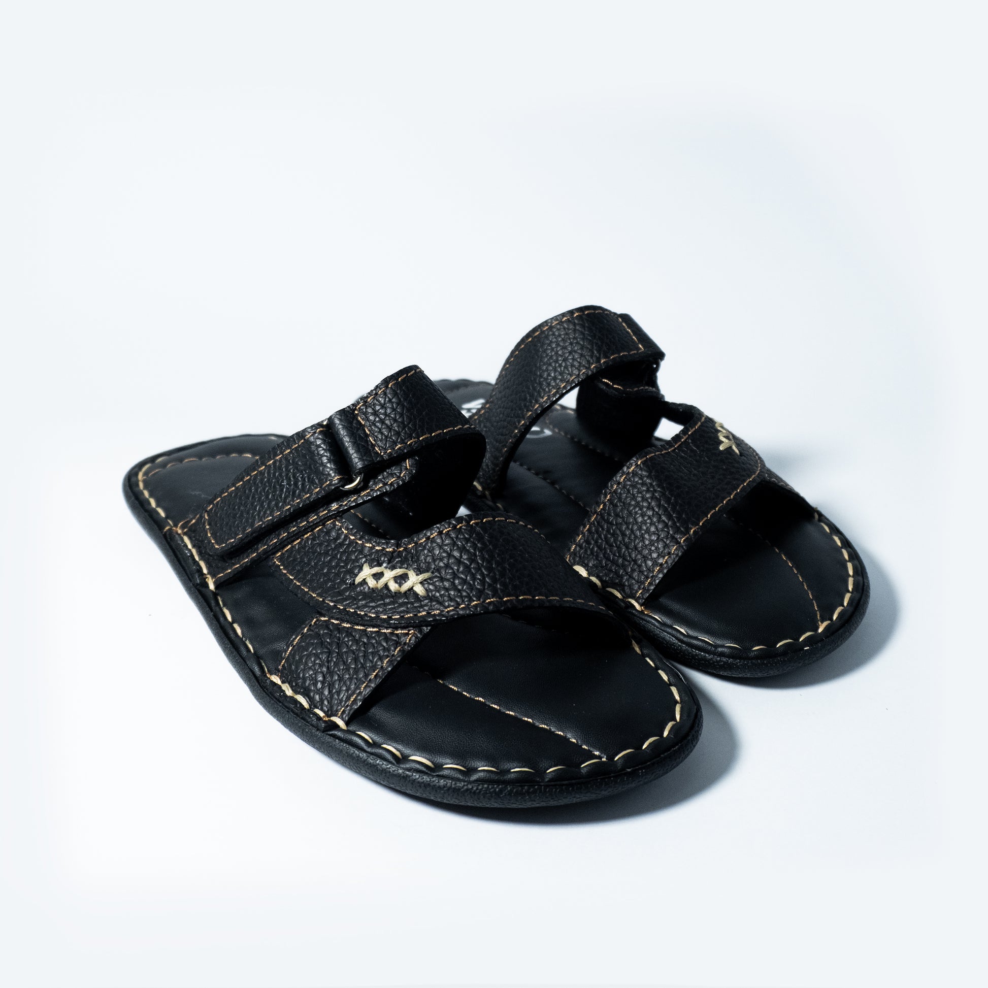 Black sandals with 'XXX' stitching on a light gray background