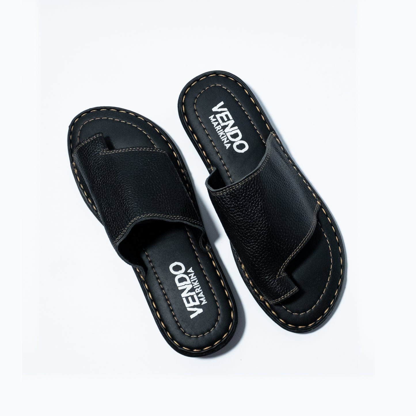 Black sandals with 'VENDO' branding on a white background