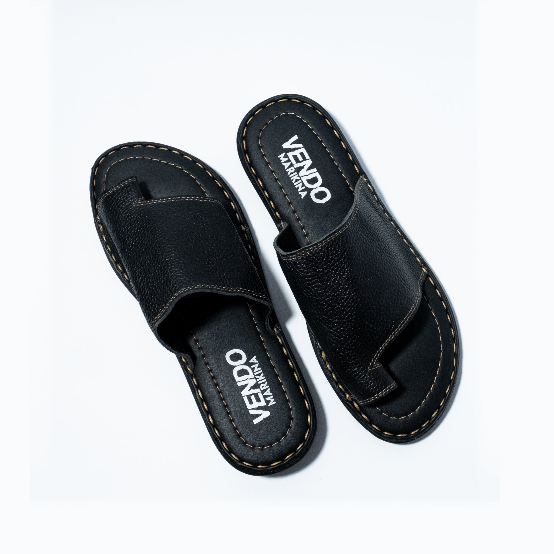 Black sandals with 'VENDO' branding on a white background