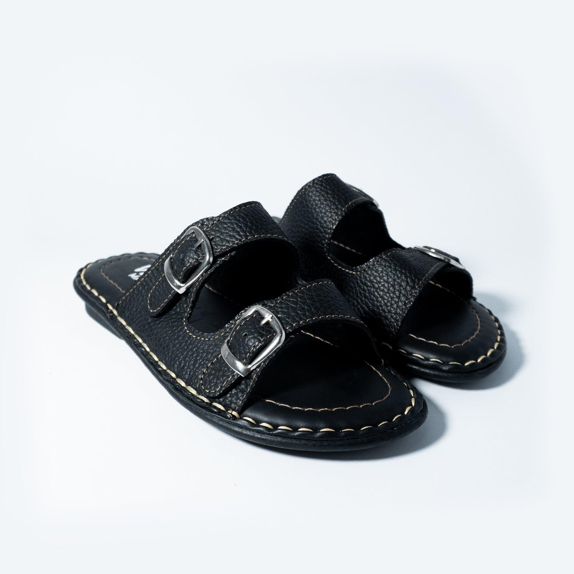 Black leather sandals with buckles on a light gray background