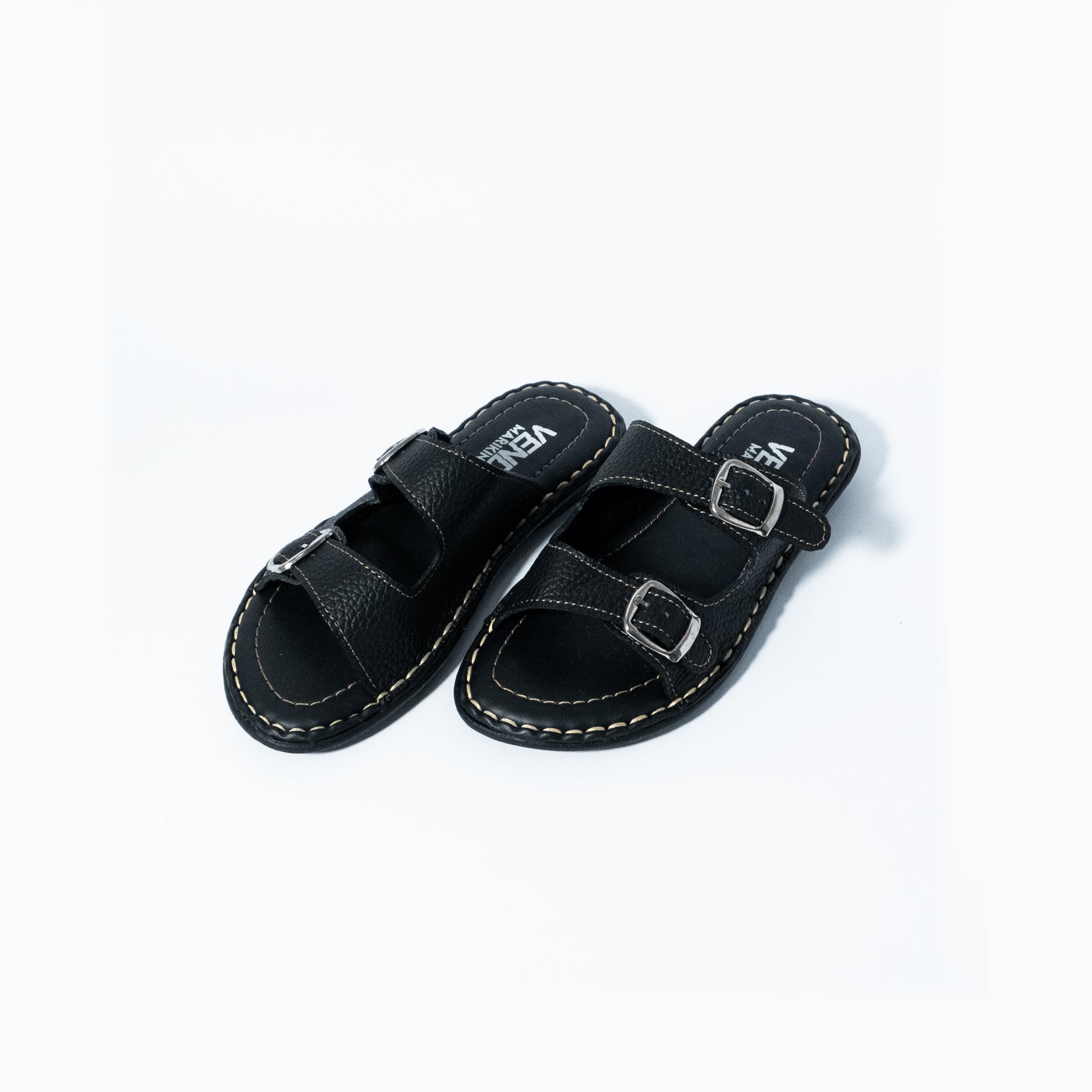 Black sandals with buckle straps on a white background