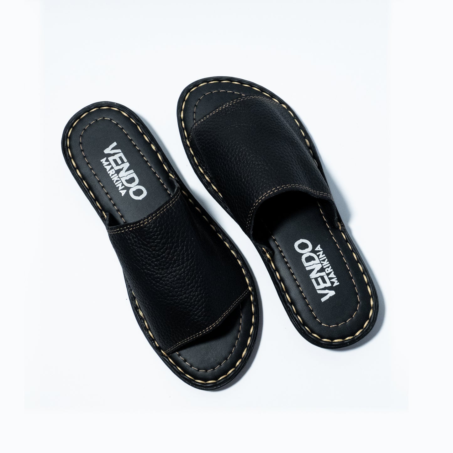 Pair of black slides with 'VENDO' branding on a white background