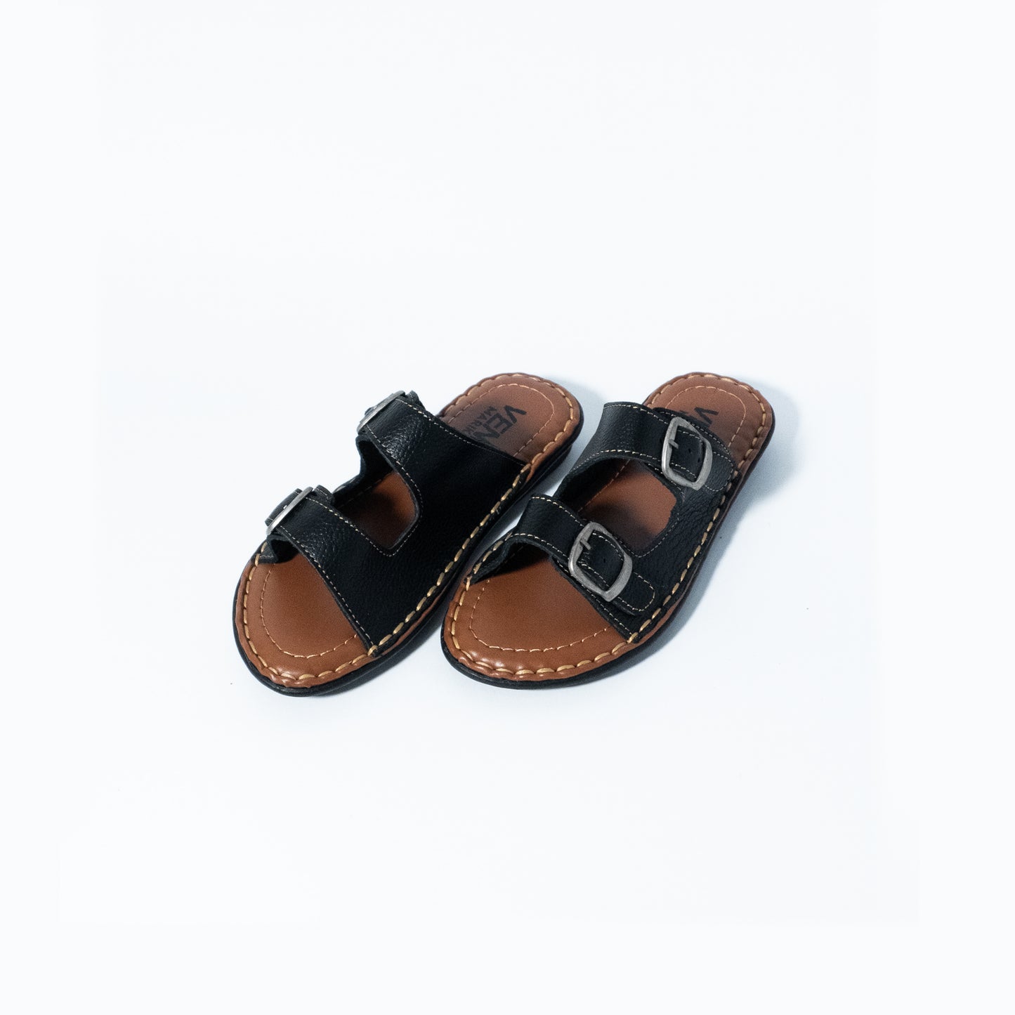 Pair of black and brown sandals on a white background