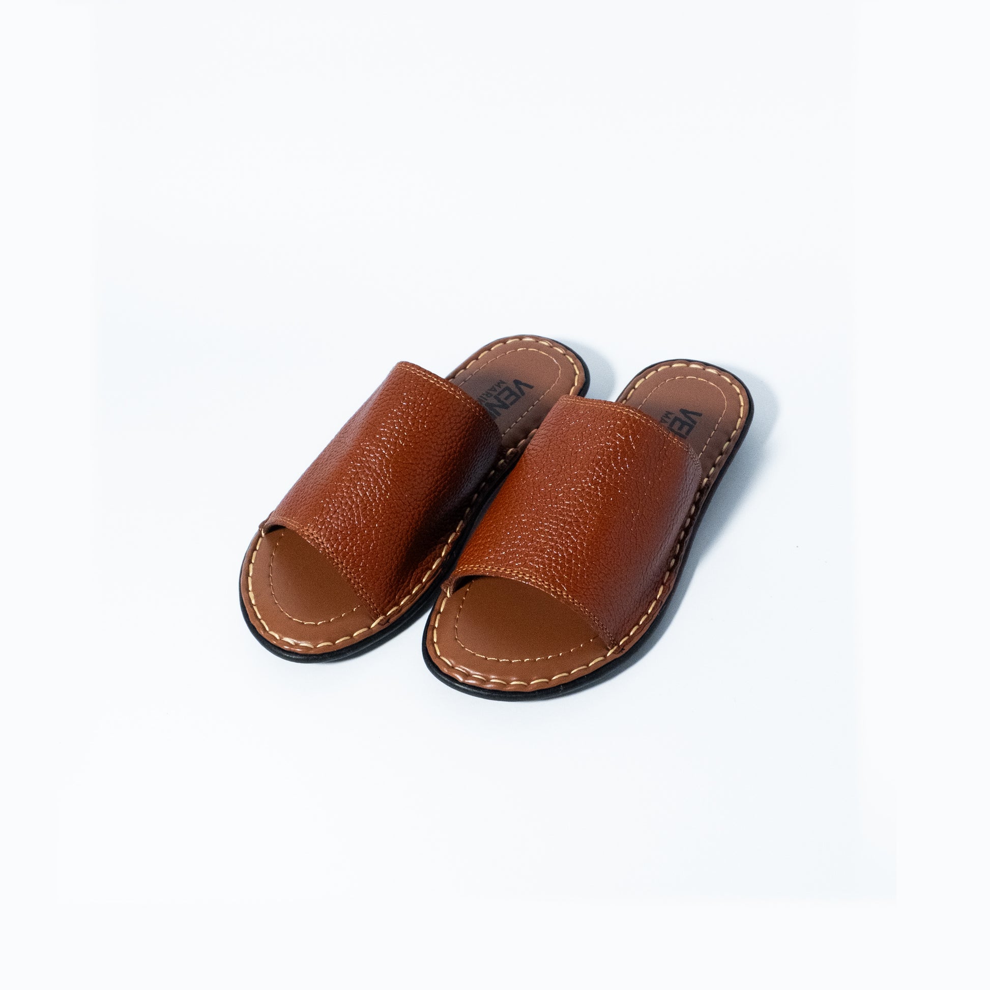 Pair of brown leather sandals on a white background