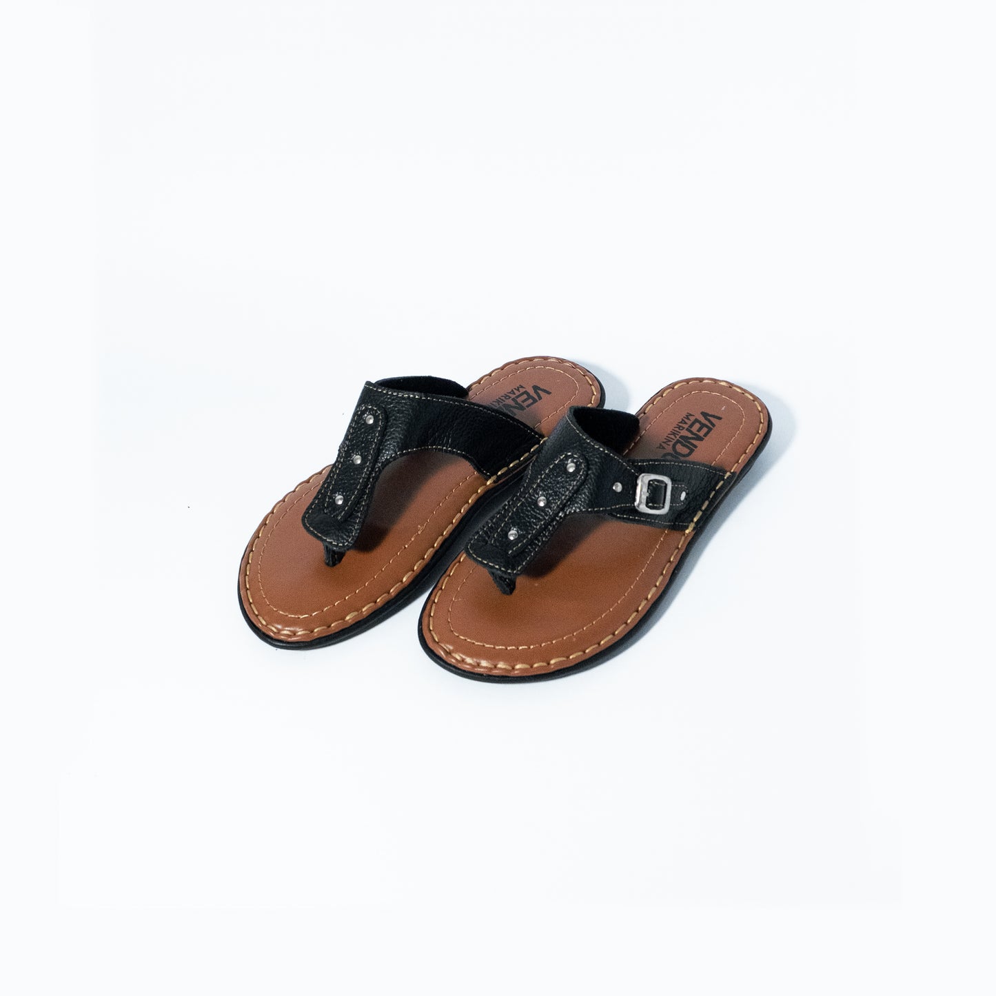 Pair of black and brown sandals on a white background