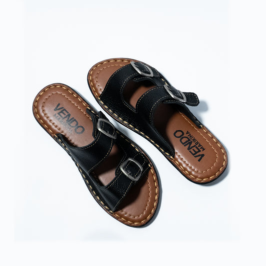 Pair of black sandals with brown soles on a white background