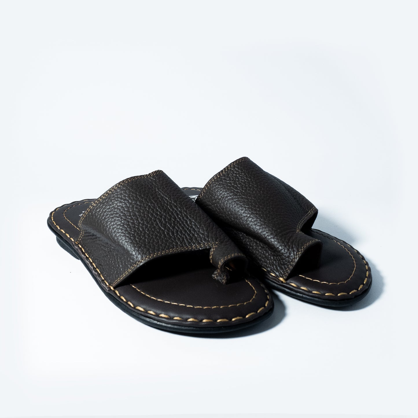 Pair of black leather sandals on a white background