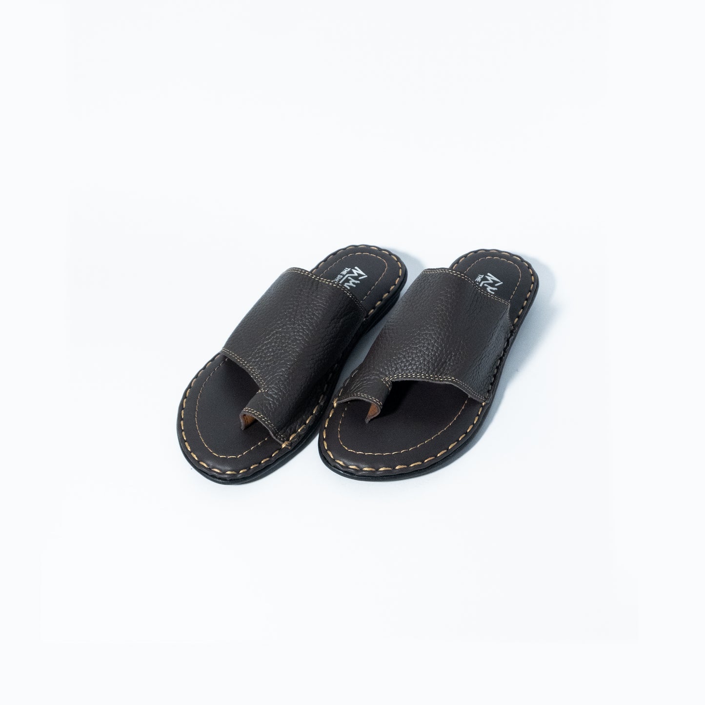 Pair of black leather sandals on a white background