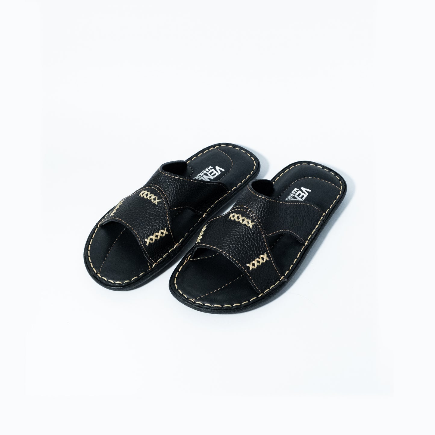 Pair of black sandals with stitching design on a white background