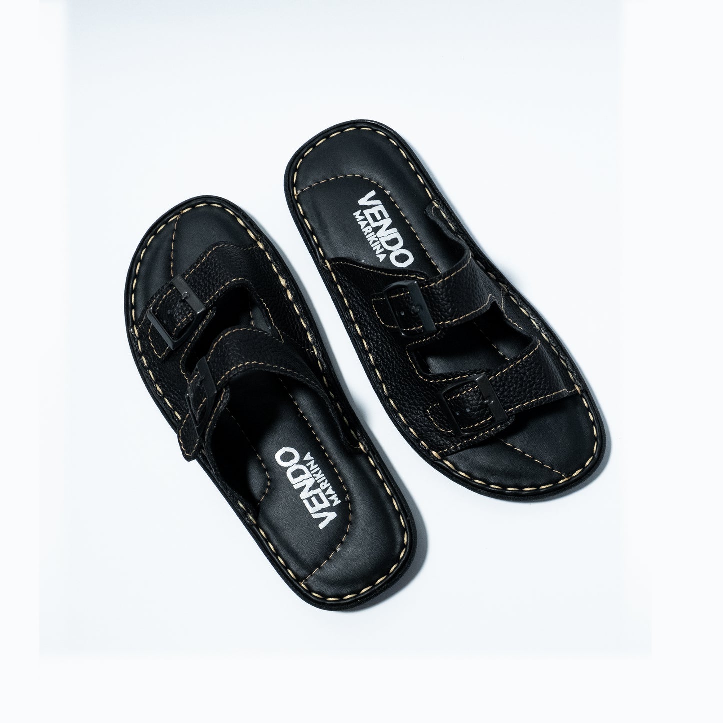 Pair of black sandals with velcro straps on a white background