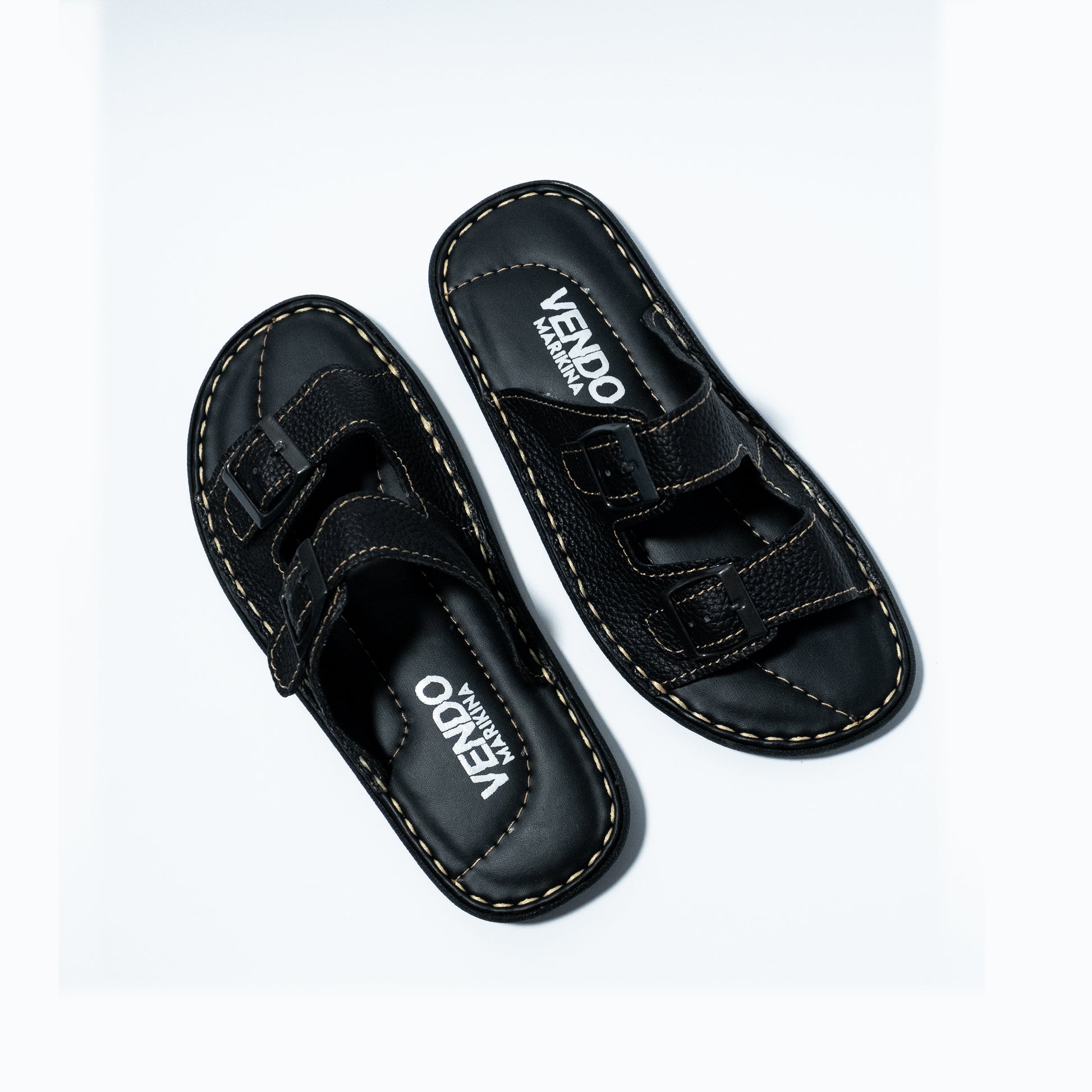 Pair of black sandals with velcro straps on a white background