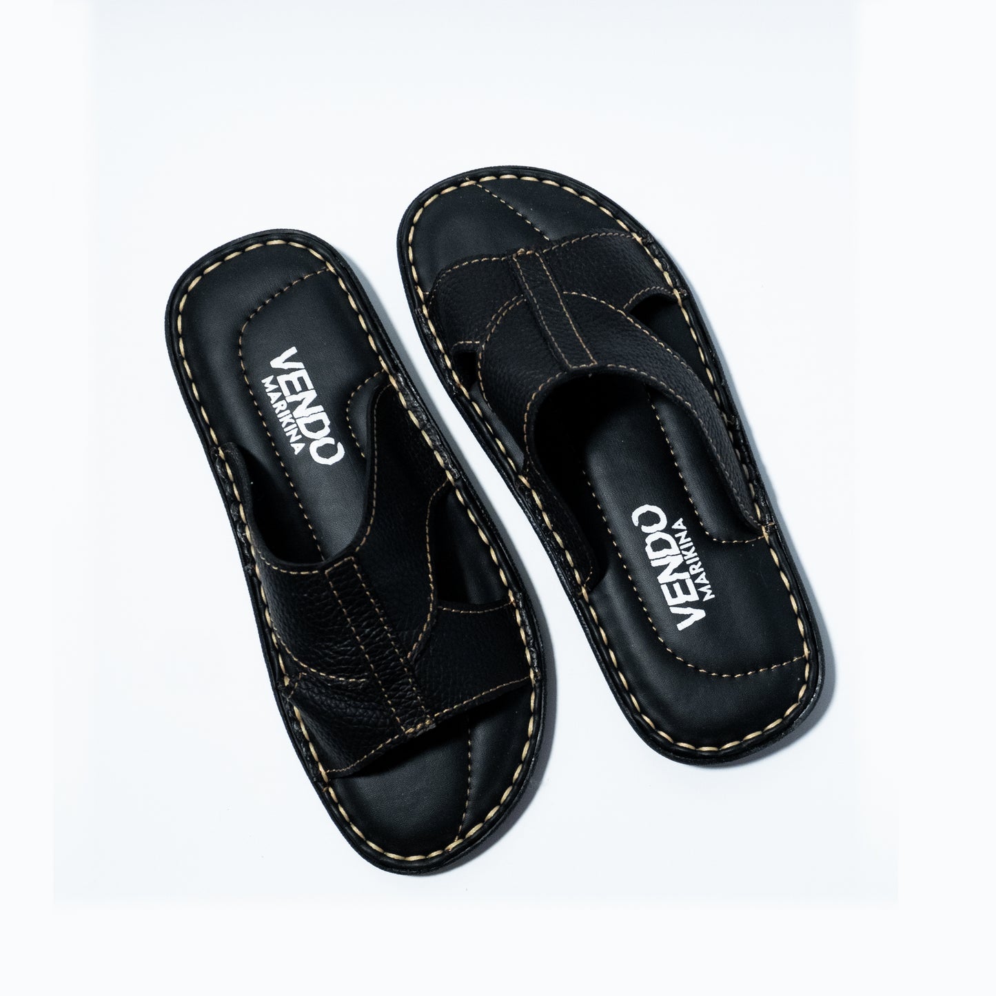 Pair of black sandals with 'VENDO' branding on a white background