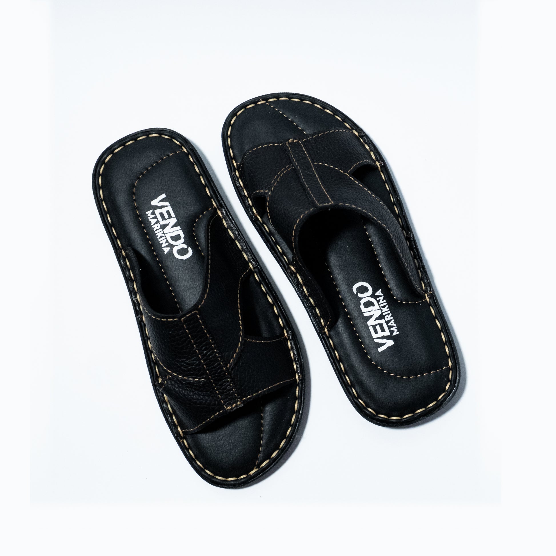 Pair of black sandals with 'VENDO' branding on a white background