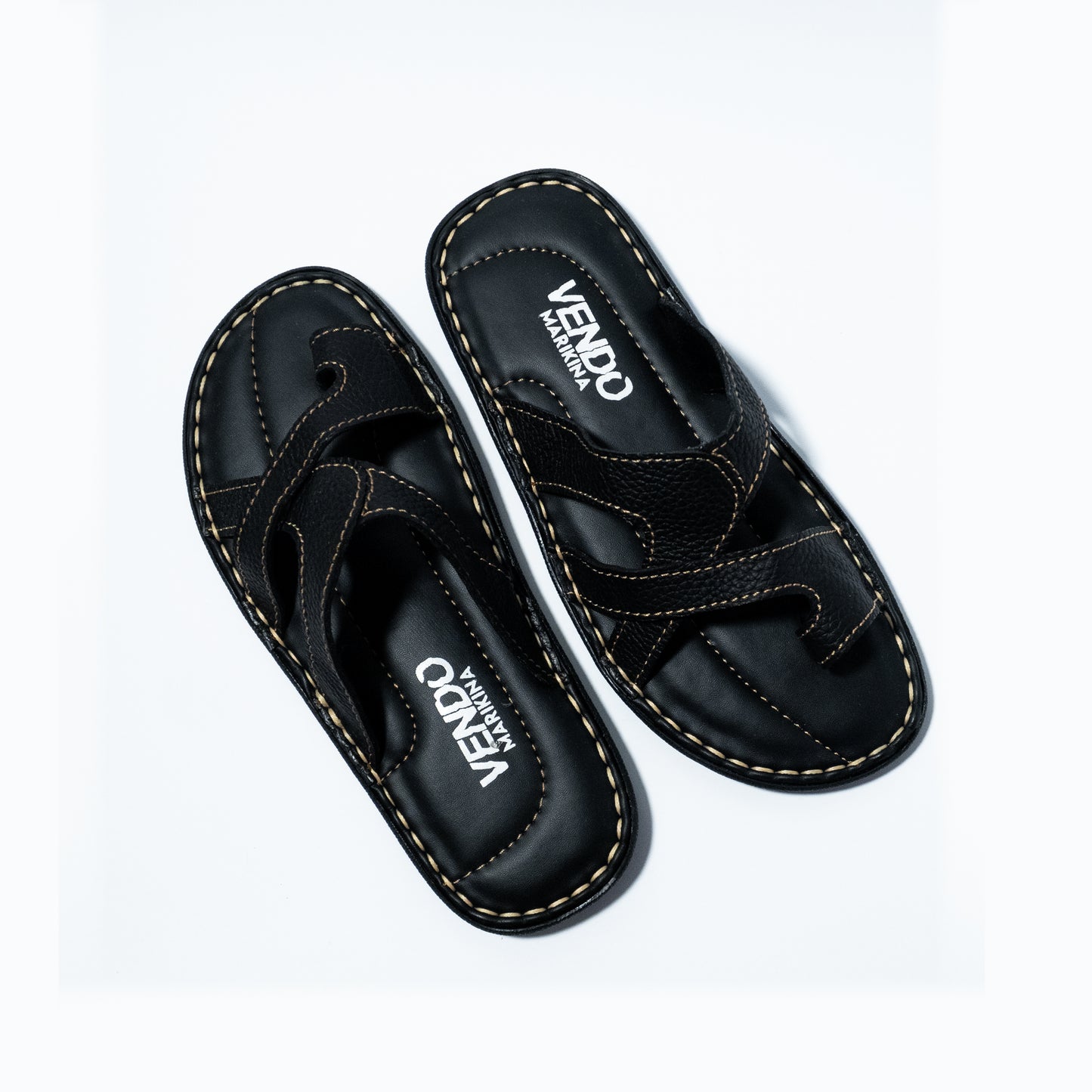 Black sandals with 'VENDO' branding on a white background