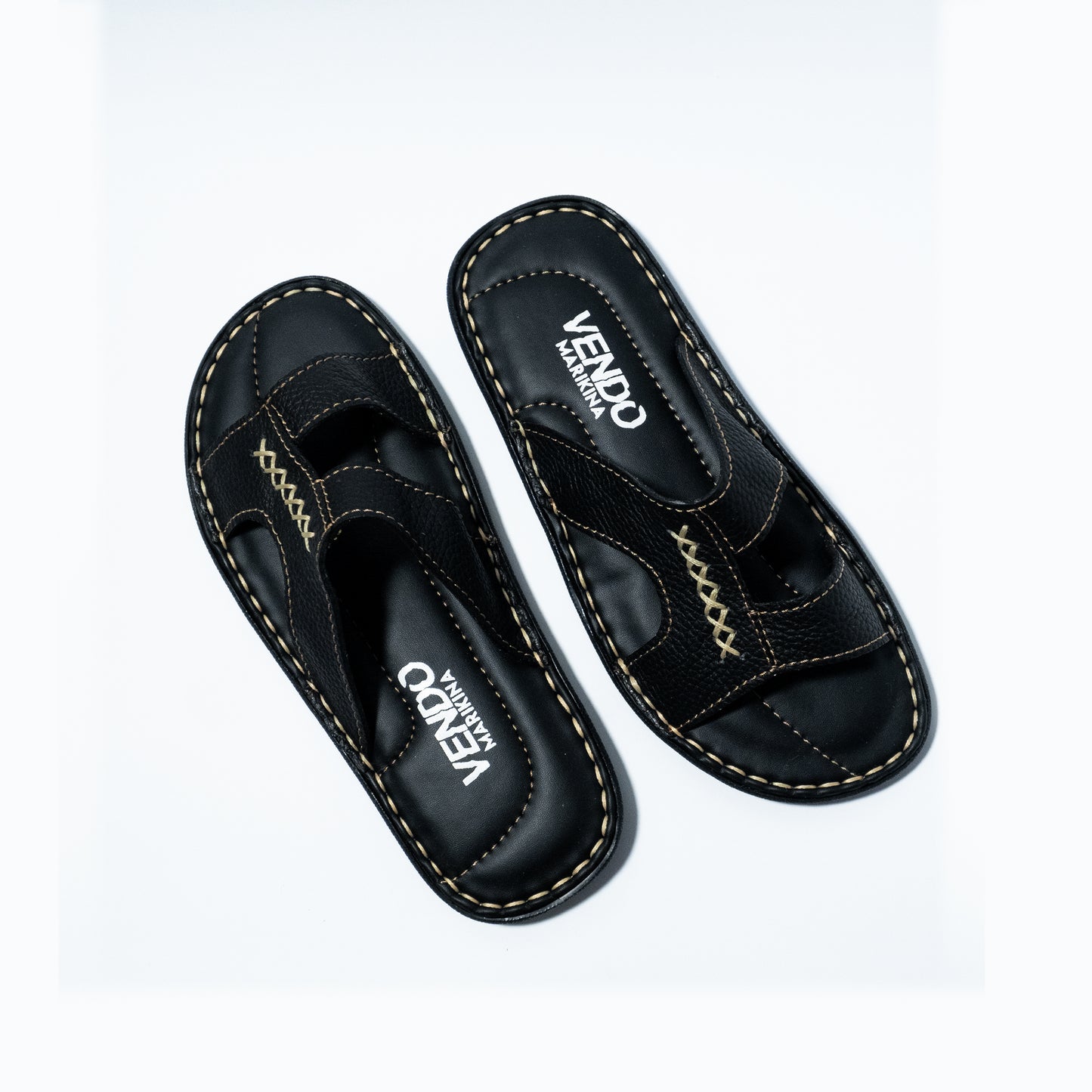 Pair of black sandals with visible branding on a white background