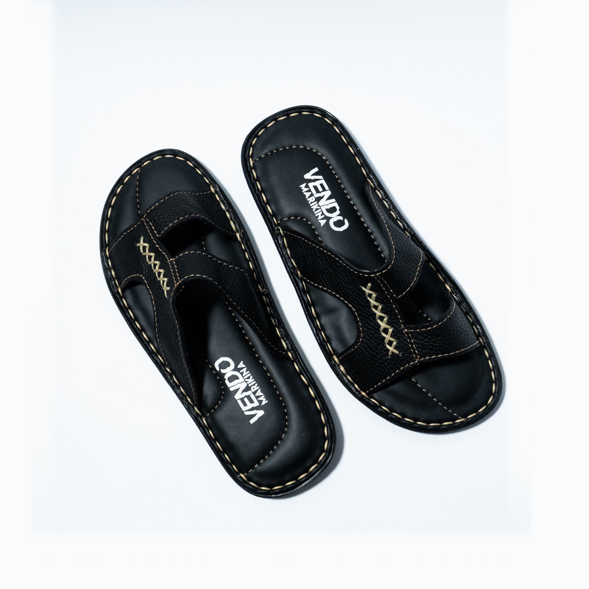 Pair of black sandals with visible branding on a white background