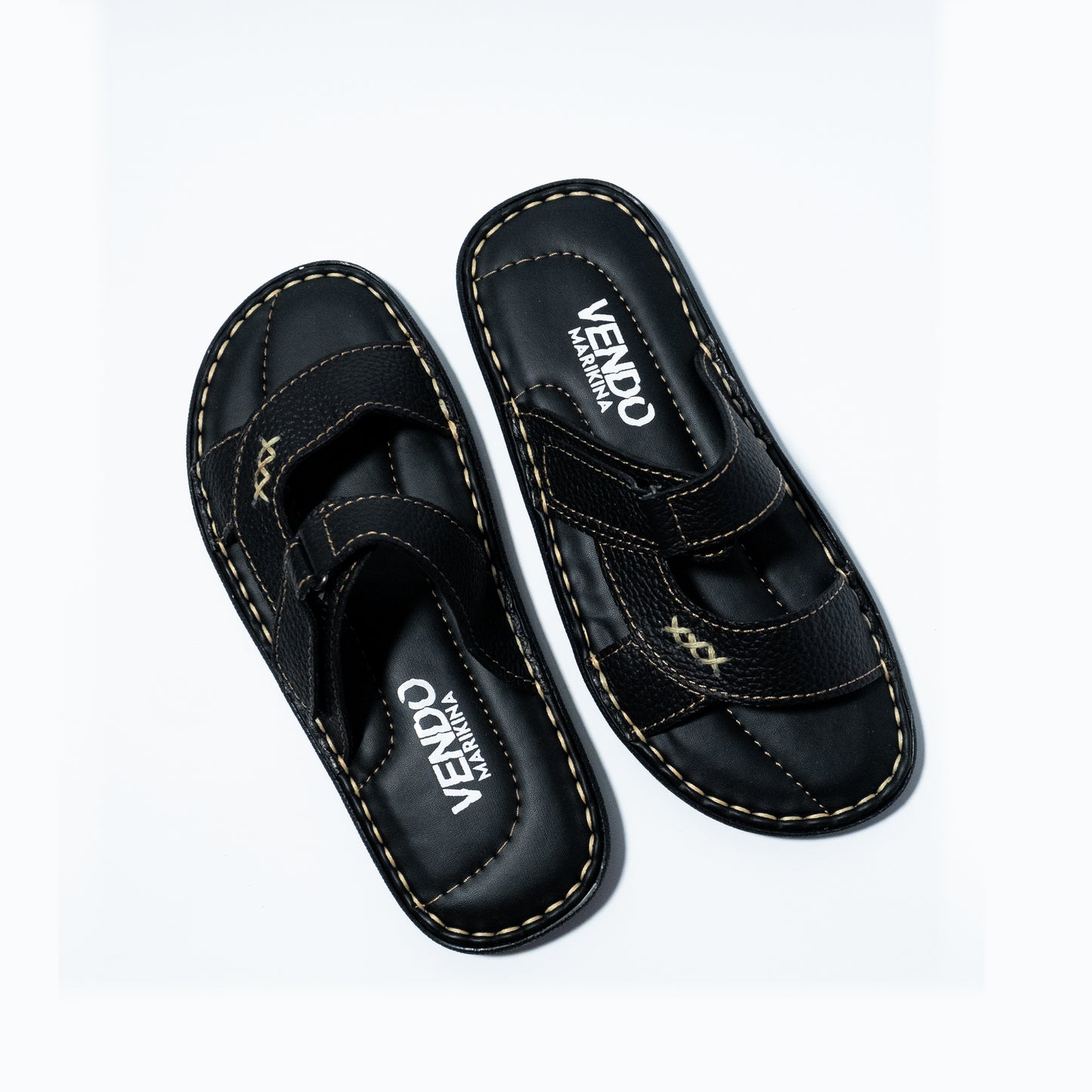 Pair of black sandals with 'VENDO' branding on a white background
