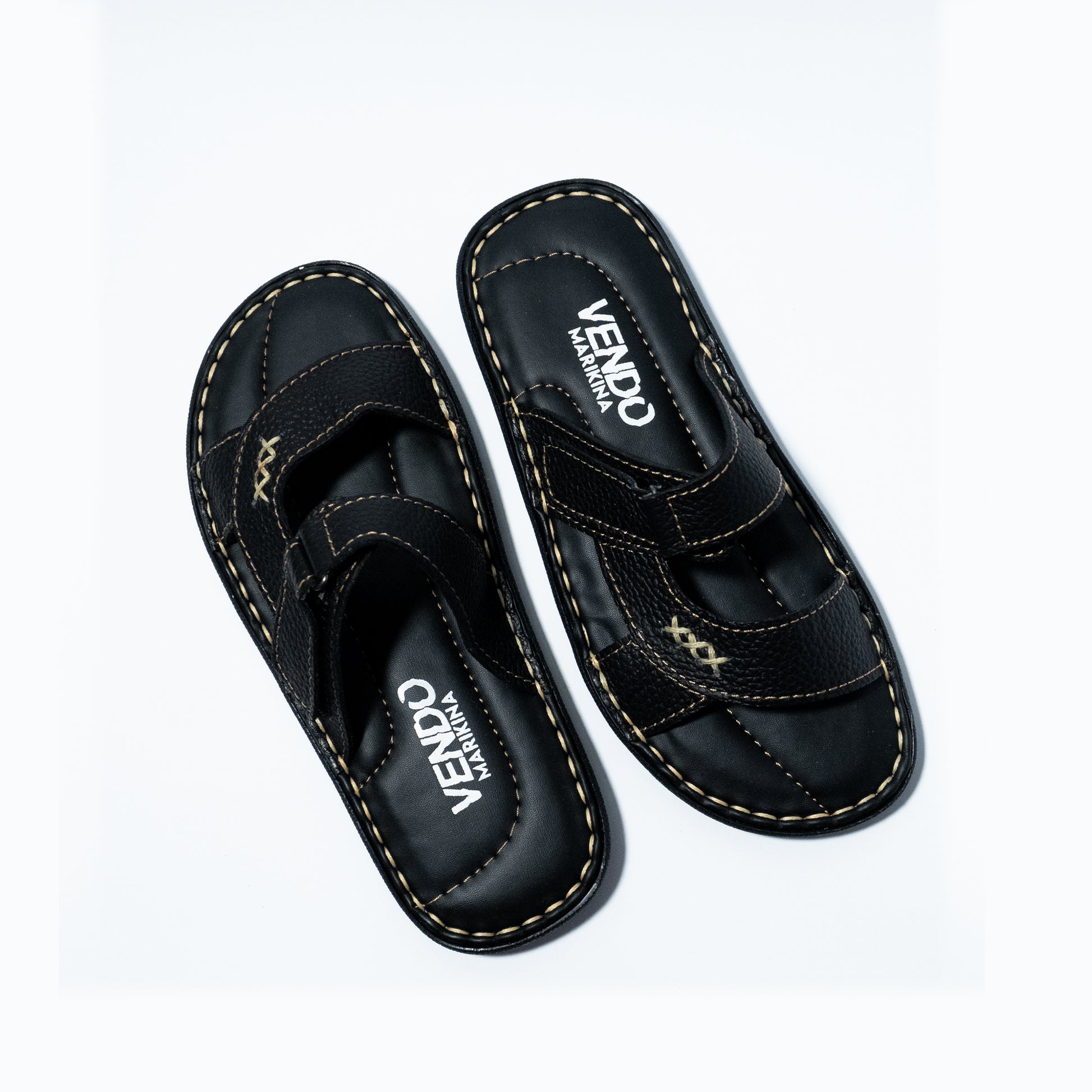 Pair of black sandals with 'VENDO' branding on a white background