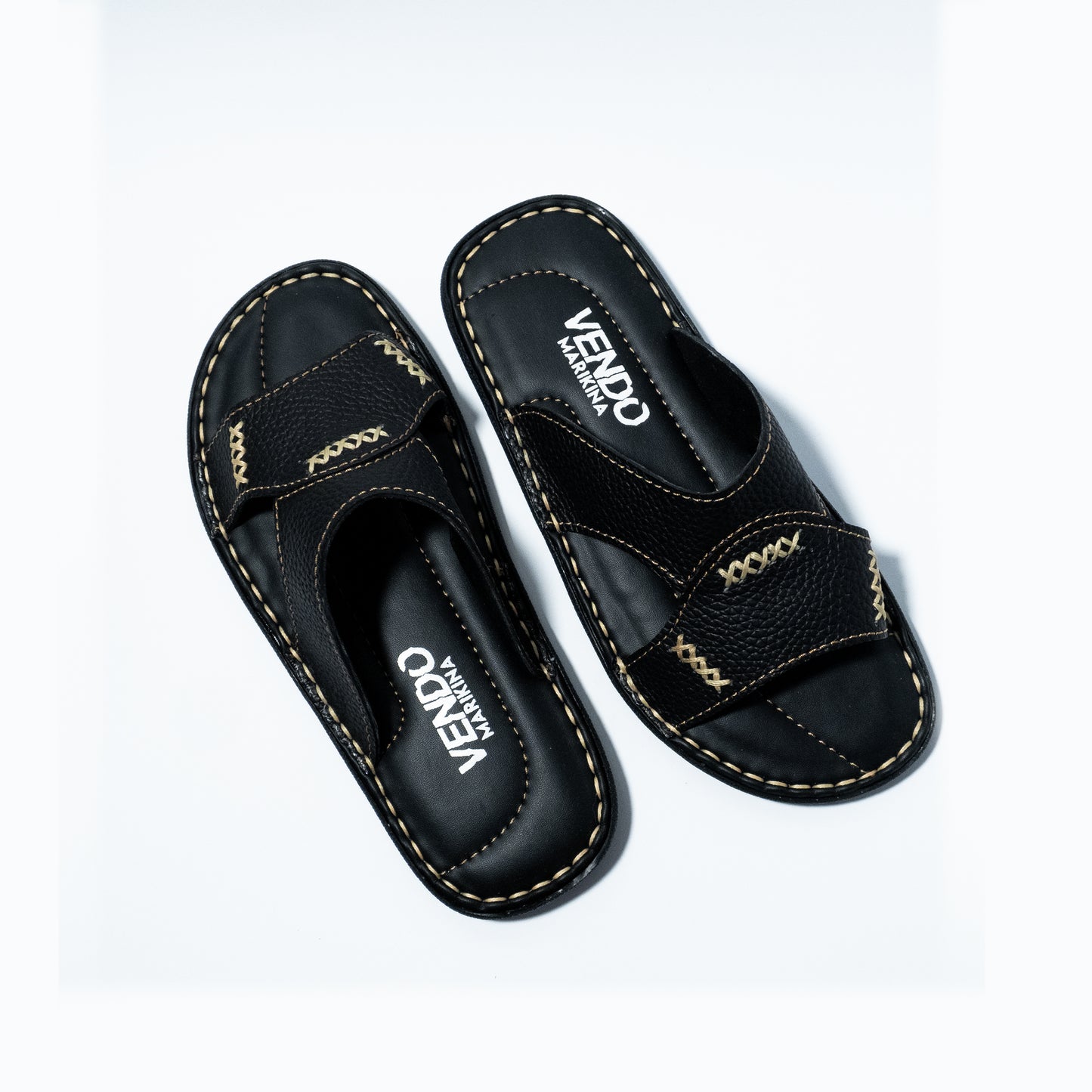 Black sandals with stitching design on a white background
