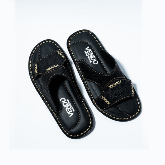 Black sandals with stitching design on a white background