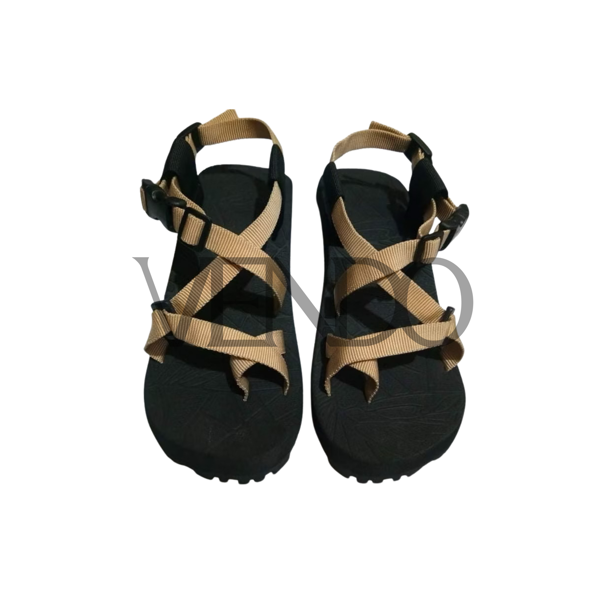 Black sandals with tan straps on a white background