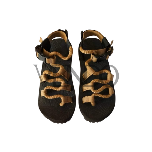 Pair of black hiking sandals with brown straps on a white background
